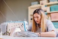 Seamstress dressmaker woman working with sewing machine in workshop Royalty Free Stock Photo