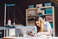 Seamstress dressmaker woman working with sewing machine in workshop Royalty Free Stock Photo