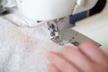 Seamstress hand guides seam on modern sewing machine Royalty Free Stock Photo