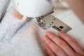 Seamstress hand guides seam on modern sewing machine Royalty Free Stock Photo