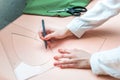 Seamstress hands close up designing clothes