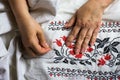 Seamstress hands. Female hands with a needle, thread and thimble. Woman embroiders clothes.