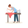 Seamstress leaned over table and hemming red cloth Royalty Free Stock Photo