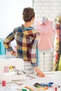 Seamstress looking on mannequin. rear view Royalty Free Stock Photo