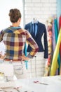 Seamstress looking on suit on mannequin Royalty Free Stock Photo