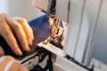 Seamstress processes edge of fabric on overlocker Royalty Free Stock Photo