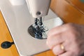 Seamstress sews clothes made of black cloth on a sewing machine Royalty Free Stock Photo