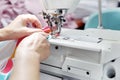 Sewing room, seamstress sews clothes on a sewing machine