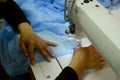 The seamstress sews on a sewing machine, fulfills the order