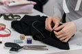 Seamstress is stitching zipper to black wide-leg pants Royalty Free Stock Photo