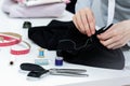 Seamstress is stitching zipper to black wide-leg pants Royalty Free Stock Photo