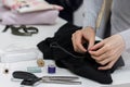 Seamstress is stitching zipper to black wide-leg pants Royalty Free Stock Photo