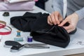 Seamstress is stitching zipper to black wide-leg pants Royalty Free Stock Photo