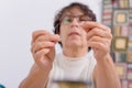 Seamstress threading a needle