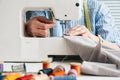 Seamstress working with electrical sewing machine