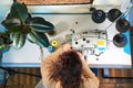 Seamstress works with sewing machine. Workplace of tailor.