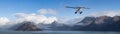 Seaplane Aircraft Flying over the Pacific Ocean Coast. Royalty Free Stock Photo