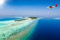 A seaplane approaching a tropical island in the Maldives Royalty Free Stock Photo