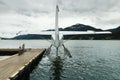 Seaplane docked at the port of Juneau with storm clouds overhead