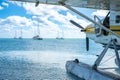 Seaplane floating in the water at Dry Tortugas National Park with distant boats.