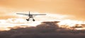 Seaplane flying over the Dramatic Cloudscape on the Pacific Ocean Coast. Royalty Free Stock Photo