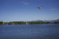Seaplane flying over lake Royalty Free Stock Photo