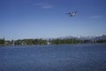 Seaplane flying over lake