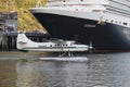 Seaplane in front of a big cruise ship in Juneau harbor Alaska.