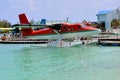 Seaplane landing on water port over turquoise water, Maldives Royalty Free Stock Photo