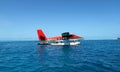 A seaplane of Maldivian Air Taxi is landed on the beautiful sea.