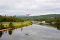 A seaplane or water plane takes off on the river in Alaska.