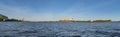 Seaport city and navigable river with ships. Panorama view