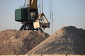 Seaport crane grabs rubble with a ladle