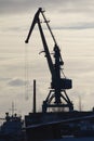 Seaport crane at sunny winter day, Silhouette
