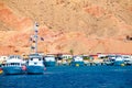 The seaport in Egypt, pier. Many white yachts in the sea, near big rock