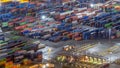 Seaport and loading docks at the port with cranes and multi-colored cargo containers night Royalty Free Stock Photo