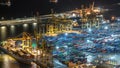 Seaport and loading docks at the port with cranes and multi-colored cargo containers night Royalty Free Stock Photo