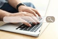 Search bar of internet browser and man working on modern laptop at table, closeup