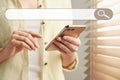 Search bar of internet browser and woman using smartphone, closeup