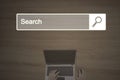 Search bar with laptop and hand