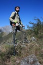 In search of buried treasures with the metal detector in a steep path between peak of the rocky and green mountains