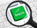 Search button under the magnifying glass Royalty Free Stock Photo