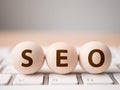 Search engine optimisation concept. Wood block sphere shape on computer keyboard with word SEO and empty copy space for your text Royalty Free Stock Photo