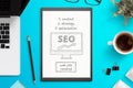 Search engine optimization sketch on white paper. Office desk, top view composition Royalty Free Stock Photo