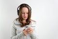 search on the phone for suitable music in the playlist teenage girl in headphones chooses a melody to listen wind Royalty Free Stock Photo