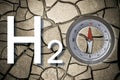 Search for water in arid soils - concept with cracked barren ground with H2O text and compass