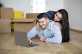 Searching Design Ideas. Happy Couple Using Laptop After Moving In New House Royalty Free Stock Photo