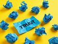 Searching for, finding or revealing the trust or reliability concept. The word trust on piece of paper among the crumpled blue Royalty Free Stock Photo