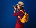 Tourist woman isolated on blue with DSLR camera taking photo Royalty Free Stock Photo