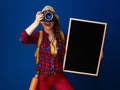 Tourist woman with blackboard and DSLR camera taking photo Royalty Free Stock Photo